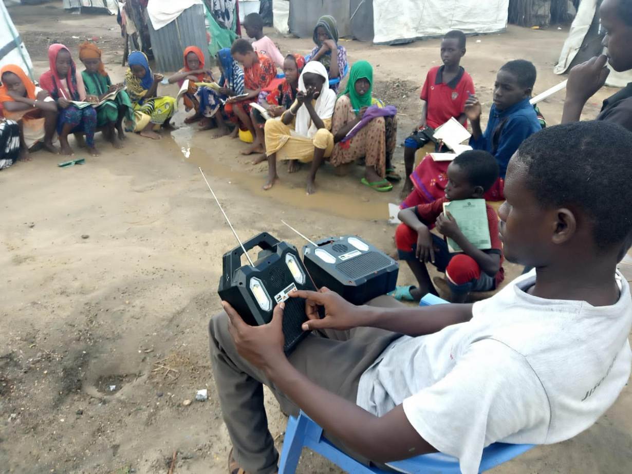 Pupils listen to school lessons broadcast over a solar radio in Dalu village, Tana River County, Kenya, November 28, 2020. | Thomson Reuters Foundation/Benson Rioba