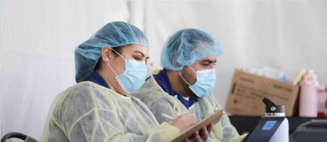 Two health workers at a COVID-19 testing site in Huntington Beach. | Courtesy of Altamed