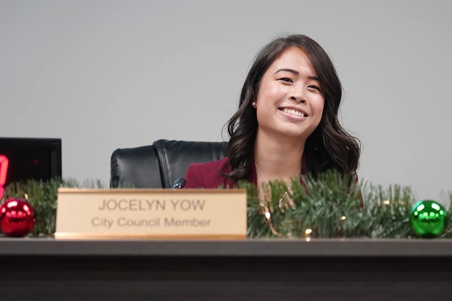 Jocelyn Yow smiles at her desk during her city council swearing in ceremony. | Courtesy of Jocelyn Yow