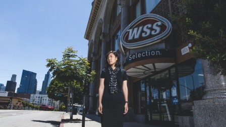 Minah Yeo stands in front of the building where her mother's business burned down during the 1992 civil unrest | Photo by Juhn Kwon