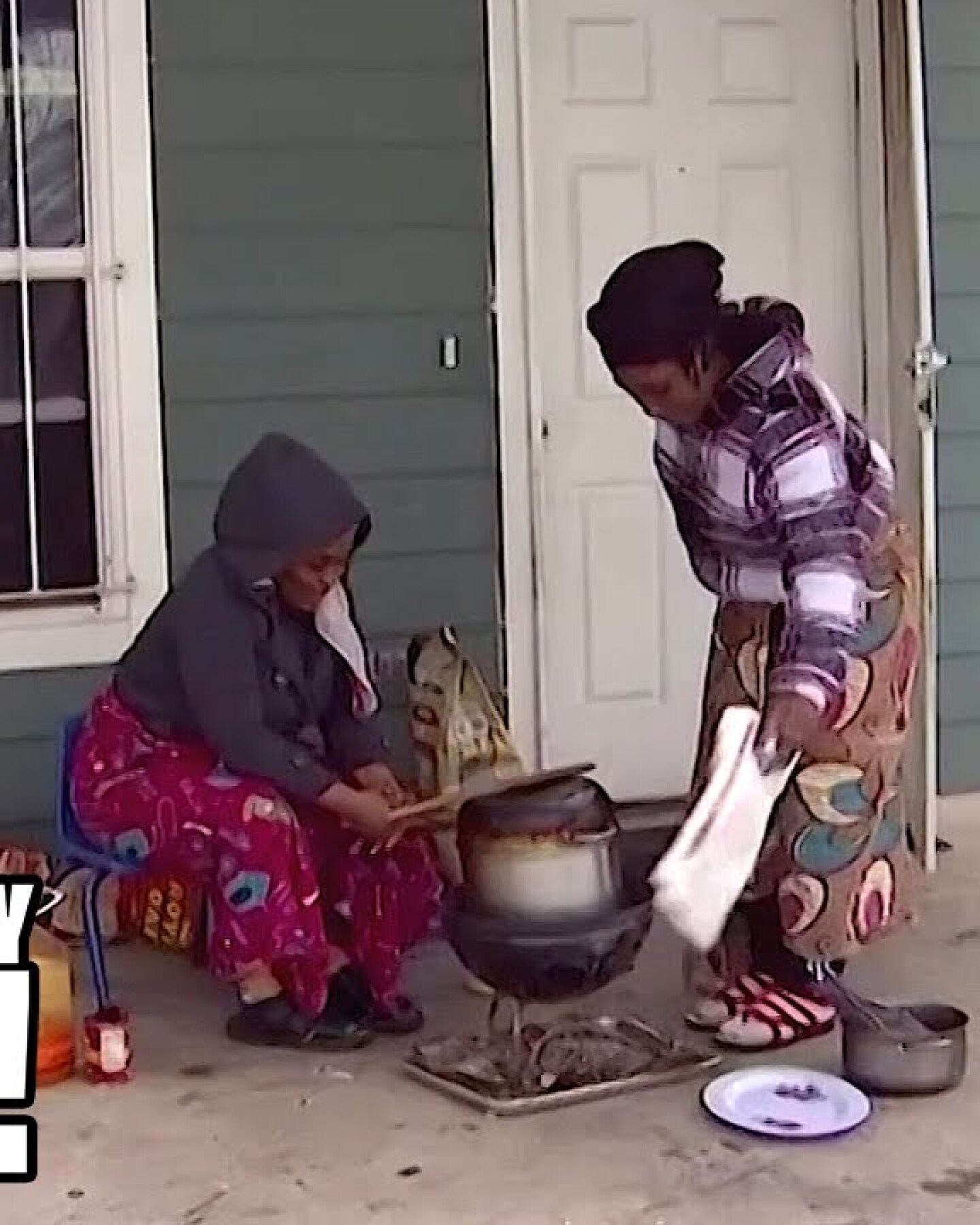 Two people tending to a pot on their porch in Texas.
