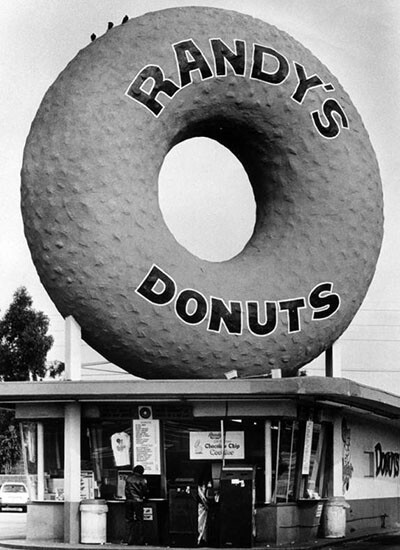 Randy's Donuts, located at 805 W. Manchester Boulevard, isn’t programmatic architecture, but its oversized signage makes it a memorable commercial landmark | Photograph courtesy of Herald Examiner Collection, Los Angeles Public Library