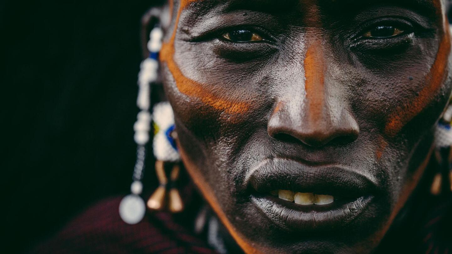 A closeup portrait of a man wearing traditional face paint. | "Forces of Nature: Elements"