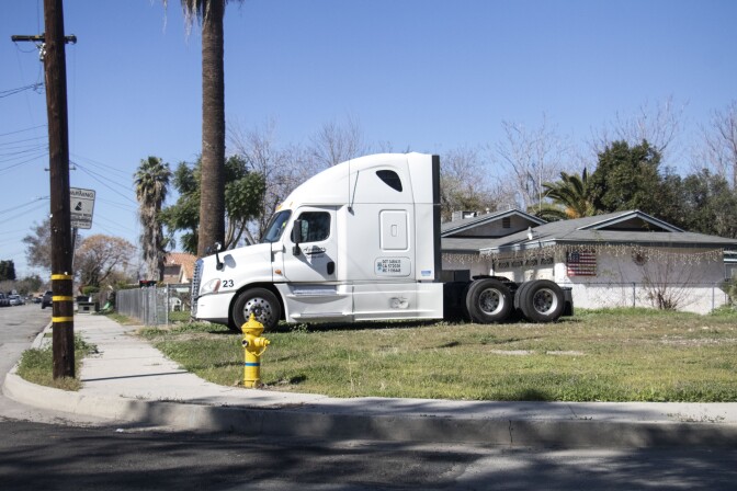 A diesel truck sits on the yard of a house on the west side of San Bernardino.