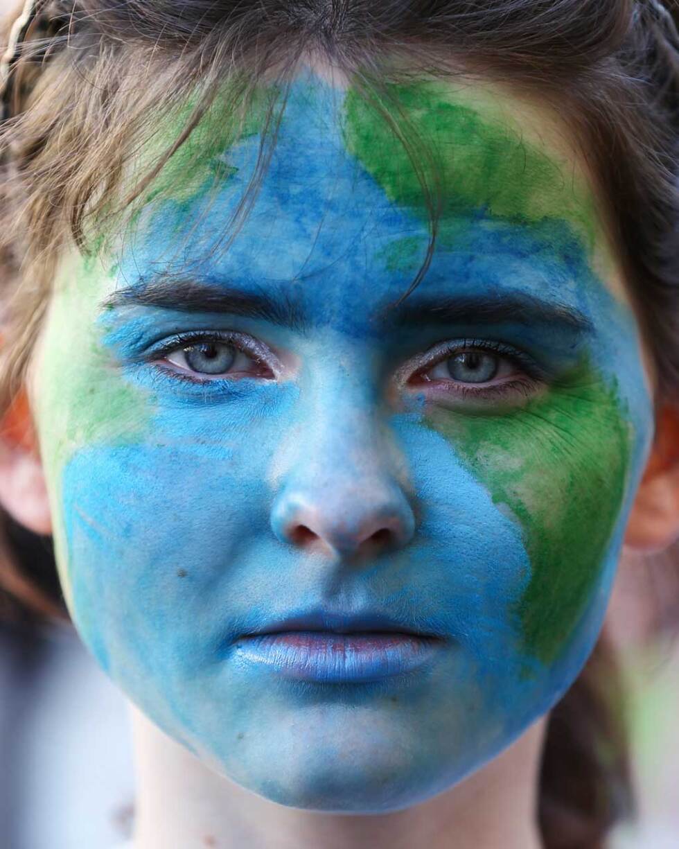 A protestor in New Zealand looks on during a strike to raise climate change awareness in September 2019. | Hagen Hopkins/Getty Images
