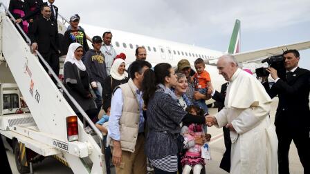 Refugees’ journey ends with a ride on the pope’s plane