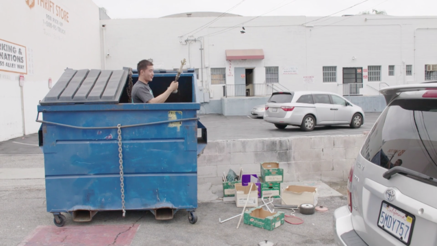 Killian Sorts Through A Dumpster
