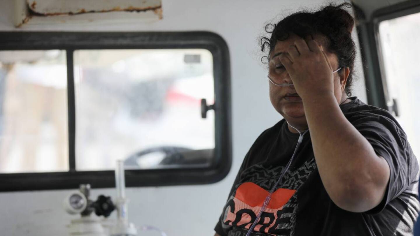 A patient suffering from the coronavirus disease (COVID-19) receives oxygen inside an ambulance after she was evacuated from the Vijay Vallabh hospital, which caught fire in Virar, on the outskirts of Mumbai, India, April 23, 2021.