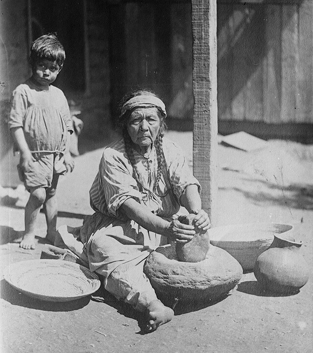 Paiute woman grinding meal on stone metate, Nevada (1900) | Huntington Library