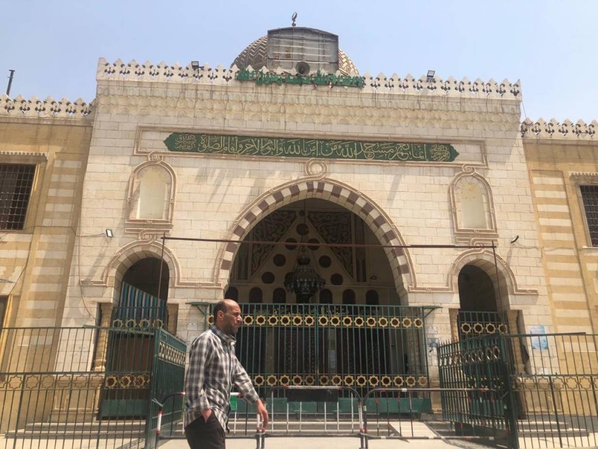 A man walks past El Sayyida Nafesa mosque located near the City of the Dead on the outskirts of Cairo after it was closed due to coronavirus fears. April 17,2020. | Thomson Reuters Foundation/Menna A. Farouk