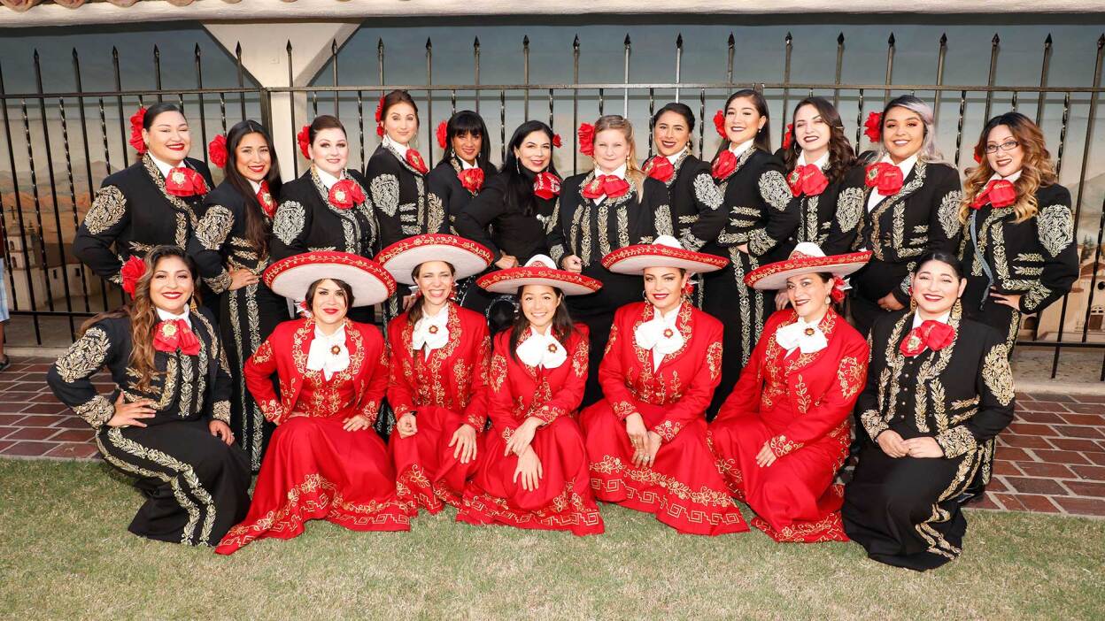 Mariachi Divas de Cindy Shea (top row), Leonor Xochitl Perez, Ph.D. (top row, sixth, clockwise) and Las Adelitas (bottom row, in red) in London at the International Mariachi Women’s Festival, July 21, 2018. | Eddie Sakaki Photographer