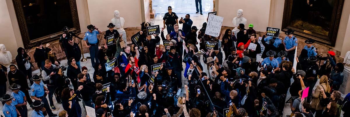 A crowd gathers in the rotunda of the Georgia State Capitol for the Count Every Vote protest in Atlanta, in 2018. | Kevin Lowery
