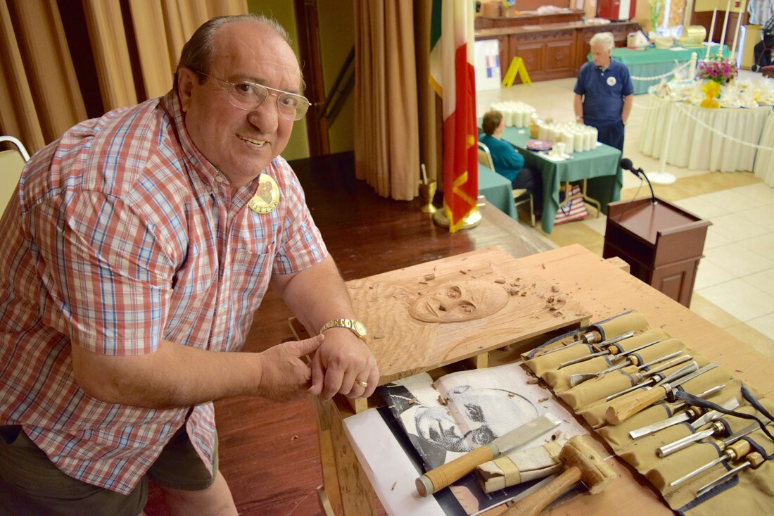 Pasquale Bruno, a committee member for St. Joseph’s Day, carves a portrait of Italian Bishop Giovanni Battista Scalabrini.