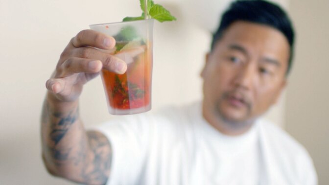 Roy Choi holds a drink prepared by PopCultivate founder Chris Yang. | Still from "Broken Bread