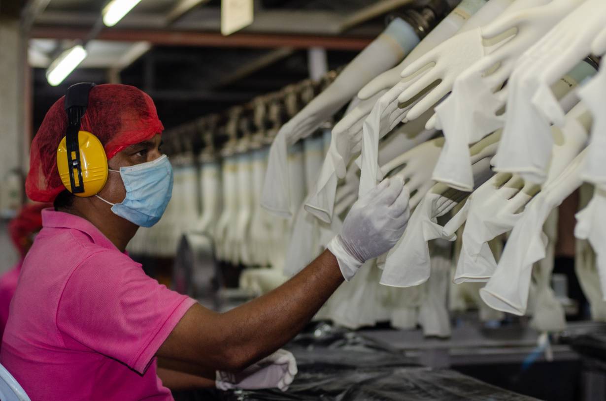 A worker makes checks at the Miditech Gloves' rubber glove factory in Malaysia in 2020. | Miditech Gloves via Thomson Reuters Foundation