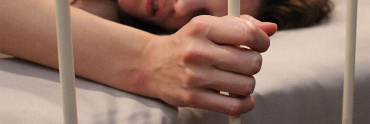 Still of a hand a bed frame from "Apartment 407." | Development Hell Pictures/Gravitas Ventures