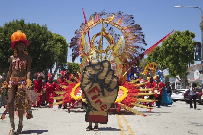 The 2017 edition of the Day of the Ancestors: Festival of Masks featured bright costumes and bold designs, like this fist emblazoned with the word "fire." | Photo by Sahra Sulaiman, Courtesy of LA Commons