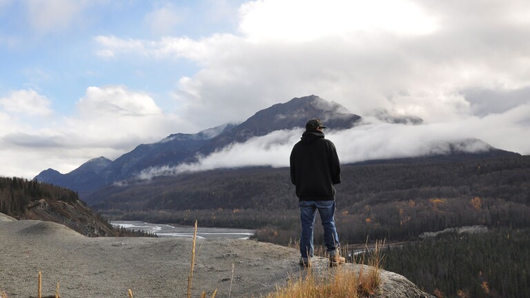 A man stands at an overlook.