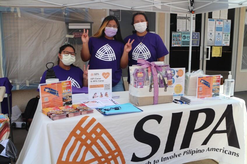 Members of Search to Involve Pilipino Americans (SIPA) table outside. SIPA offers mental health programs and other basic needs to Filipino communities.
