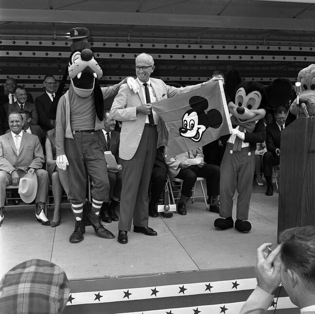 Visitors from Disneyland present a sort of pennant to Angels manager Bill Rigney at the Anaheim Stadium groundbreaking.