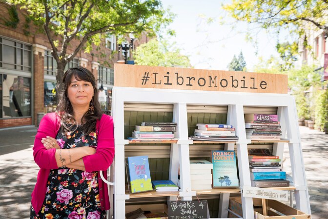 Sarah Rafael García poses next to her LibroMobile mobile library. | Courtesy of Sarah Rafael García