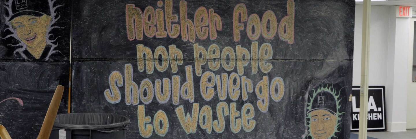 Participants of L.A. Kitchen's food culinary training program chop vegetables. | Still from video by Chase Alexander