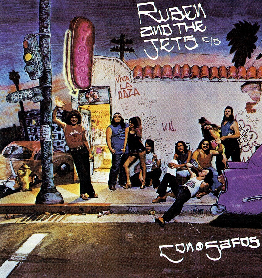 An illustration of a street corner in Los Angeles with men and women hanging out. On the side, there is graffiti that says "Viva La Raza." The album title is "Ruben and the Jets."