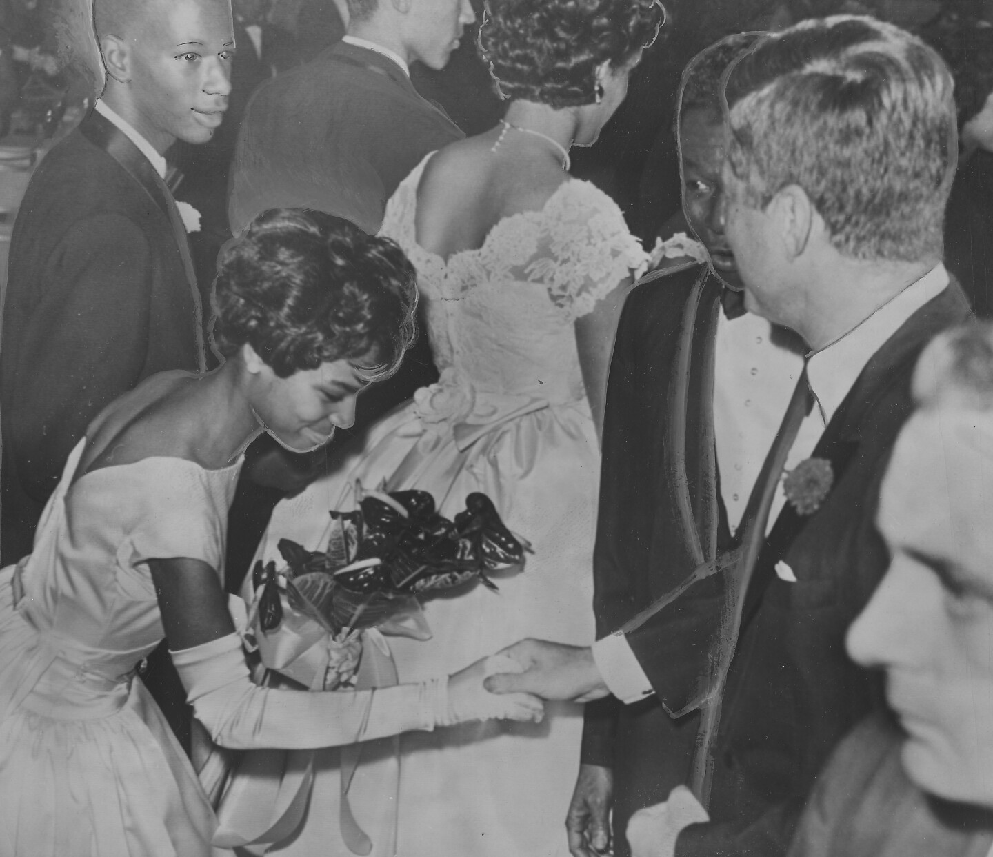 Nat King Cole And John F. Kennedy greet an African American debutante.