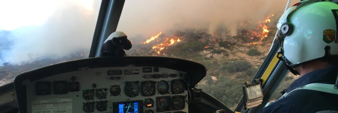 A helicopter pilot flies over a fire. | Courtesy of Cliff Walters