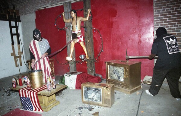 A performance piece by Raul Baltazar (left), Joe Galarza (middle) and Gene Johnson commenting on capitalization and patriarchy as they demolish televisions. Photo courtesy of Antonio Garcia.