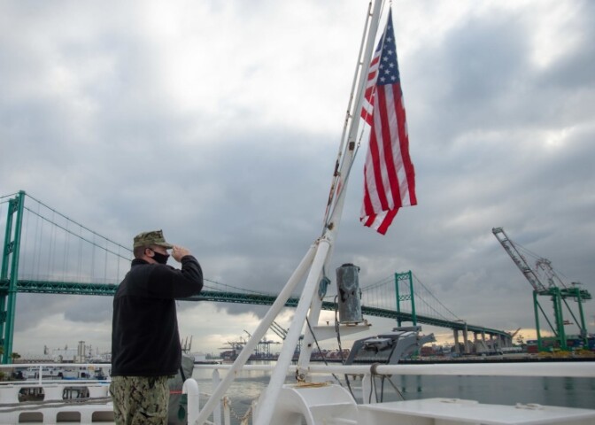 Sailor John Arkulary salutes the flag aboard the hospital ship USNS Mercy in Los Angeles April 13. | Luke Cunningham/US Navy