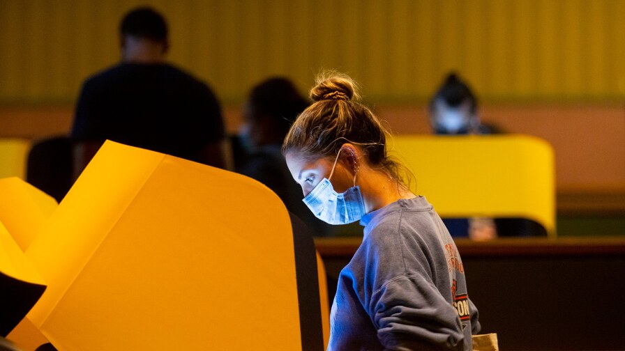 Ana Figueroa, 33, of Los Angeles, CA casts her ballot at a voting center inside The Wiltern on election day. on Tuesday, Nov. 3, 2020 in Los Angeles, CA. | Francine Orr / Los Angeles Times