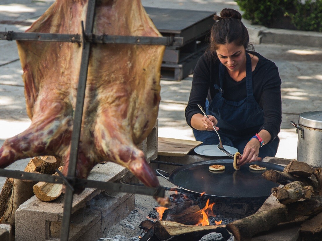 Chef Debbie Michail performing whole animal roast