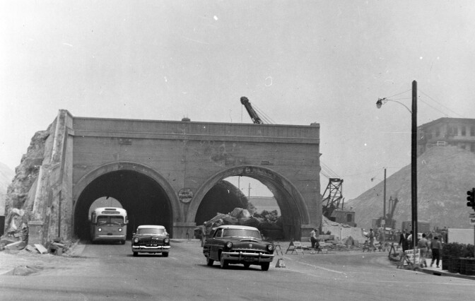 Road cuts and hill regrading transformed several of downtown Los Angeles' tunnels, like the Hill Street Tunnels, shown here at 1st Street in 1955, into mere arches. Courtesy of the Photo Collection - Los Angeles Public Library.