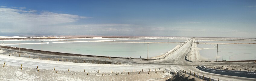 The Atacama salt flats contain one of the largest reserves of lithium-brine in the world. Large, man-made, lithium-brine pools stretch out into the distance.