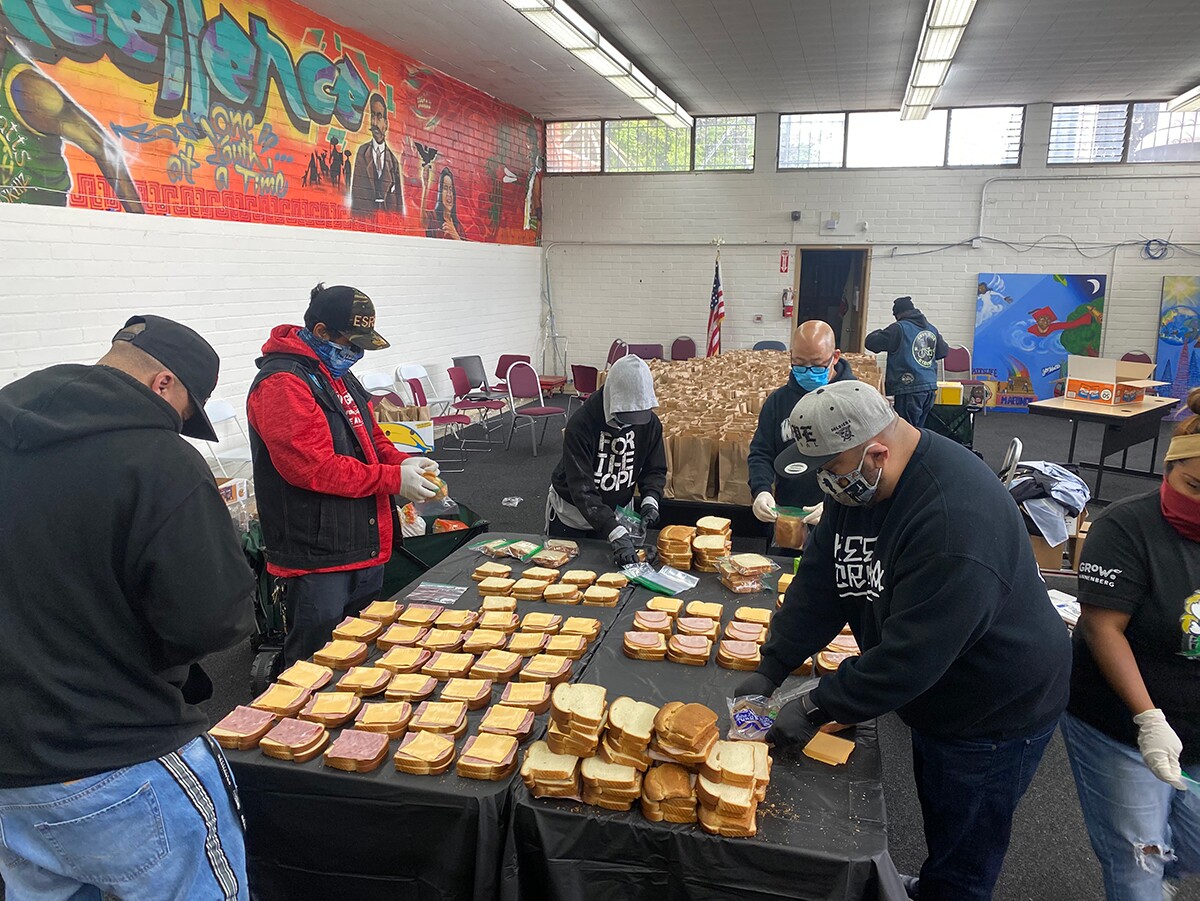 Members of East Side Riders Bike Club assemble meal packages