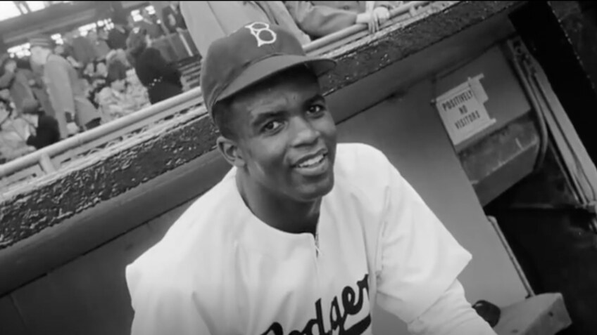 Black and white photo of an African American man in a white Dodgers uniform.