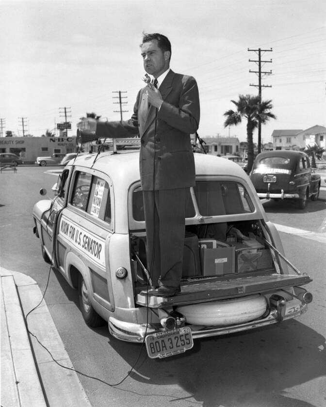 Congressman Richard M. Nixon delivers a stump speech from the back of his "Yellow Woody" Mercury Station Wagon during his successful 1950 U.S. Senate campaign, Garden Grove, April 28, 1950.