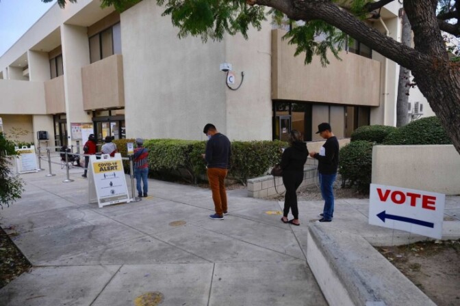 People wait in line to vote at the O.C. Registrar. | Chava Sanchez/LAist