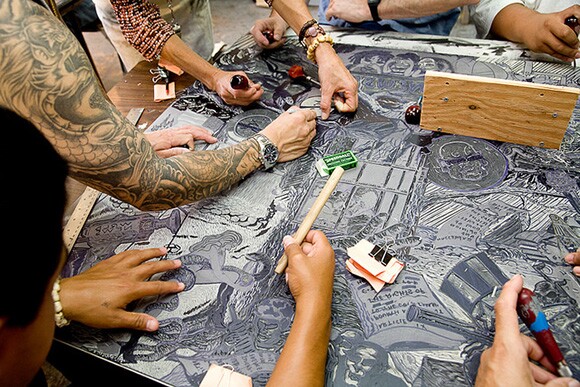 Printmaking class -- carving a linoleum block, San Quentin State Prison. | Photo: Peter Merts