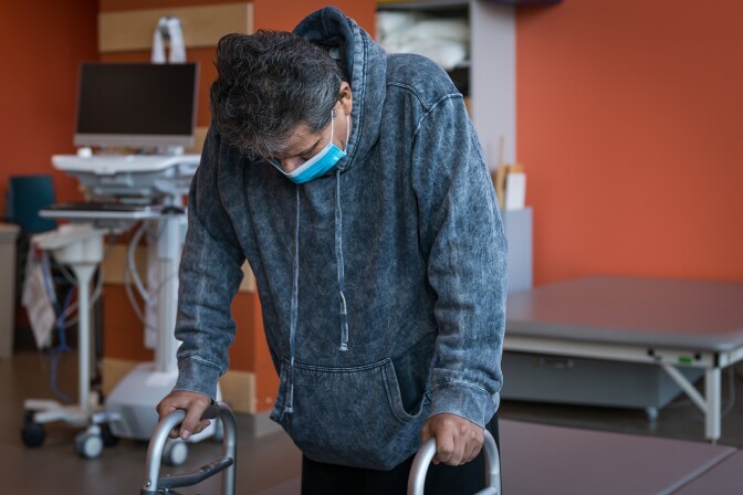 Perez takes a break during his therapy. He could barely breathe when he was admitted to Los Angeles County’s Harbor-UCLA Medical Center in early June of last year.