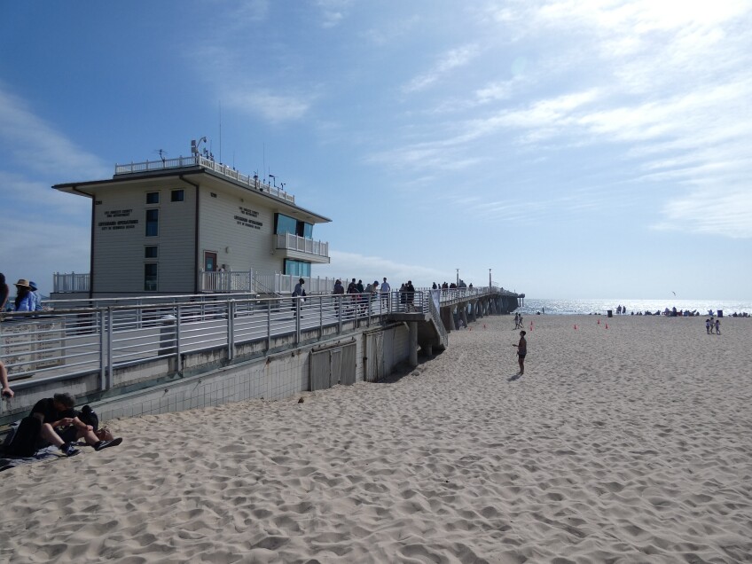 Hermosa Beach Pier made up of now concrete extends out to the beach.