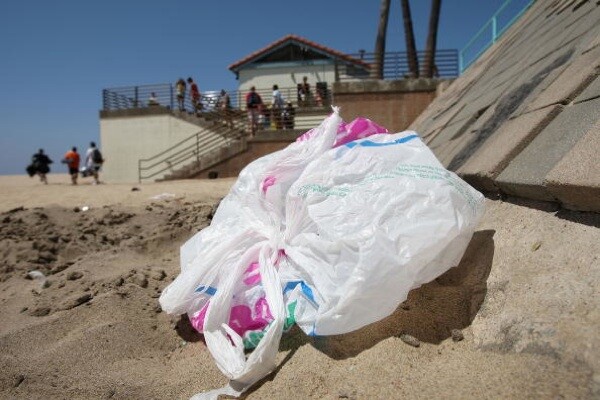 The wind blows a plastic bag around the beach near the Manhattan Beach Pier | Photo by David McNew/Getty Images