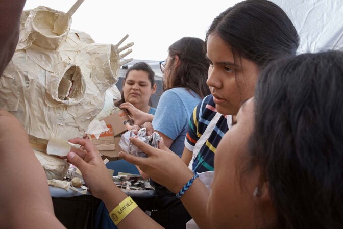 Young girls work on a sculpture at Self Help Graphics' Dia de los Muertos season of workshops, 2019. | Ken Marchionno