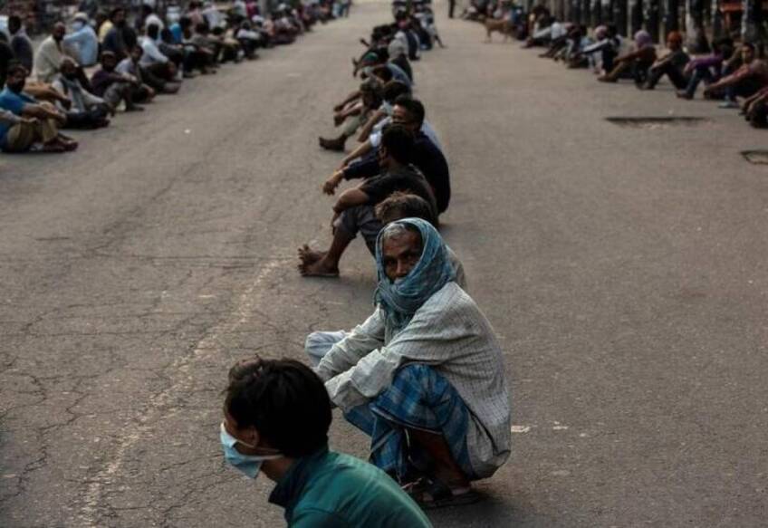 Daily wage laborers and homeless people wait to receive free food during an extended nationwide lockdown to slow the spread of the coronavirus disease (COVID-19) in New Delhi, India, April 28, 2020. | REUTERS/Danish Siddiqui
