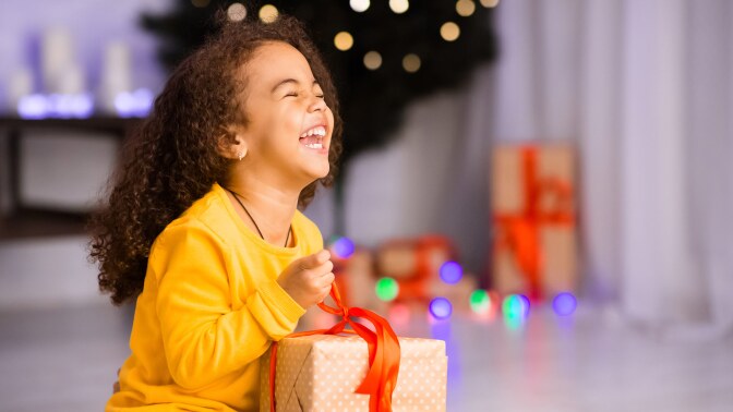 child opening a gift christmas