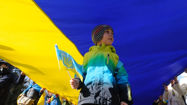 Little boy seen holding a Ukrainian flag in his hand during the Unity march on the Ukraine-Russia border.