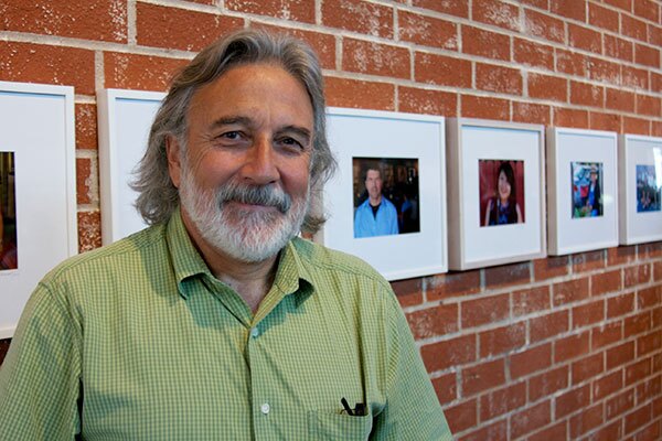 Ricardo Palavecino with his portraits