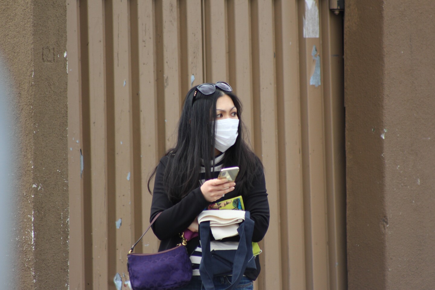Woman looks to her left wearing a face mask | Karen Foshay