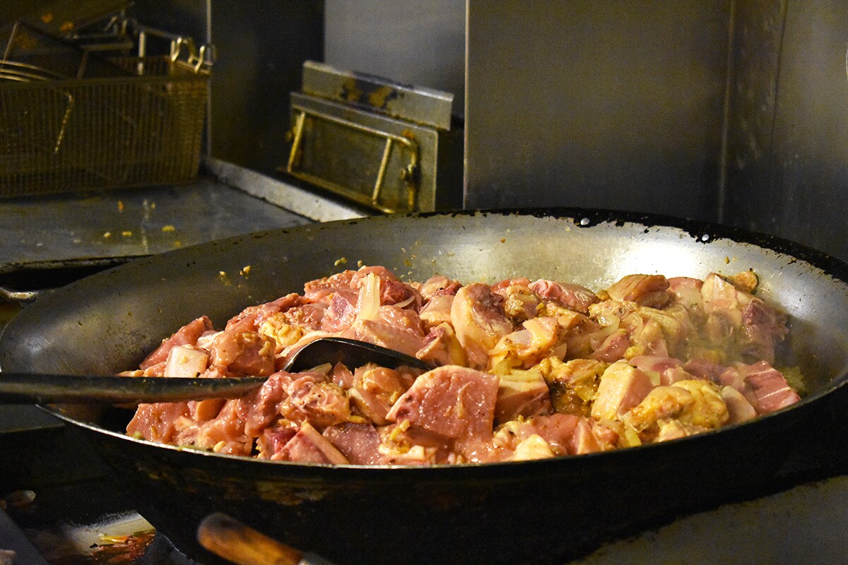 A wok full of meat cooking away as a future dish to refill the turo-turo food offerings. | Jacqueline Lee
